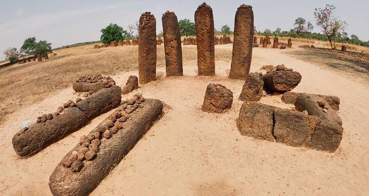 Ancient laterite stone circles and burial pillars in rural Senegal.