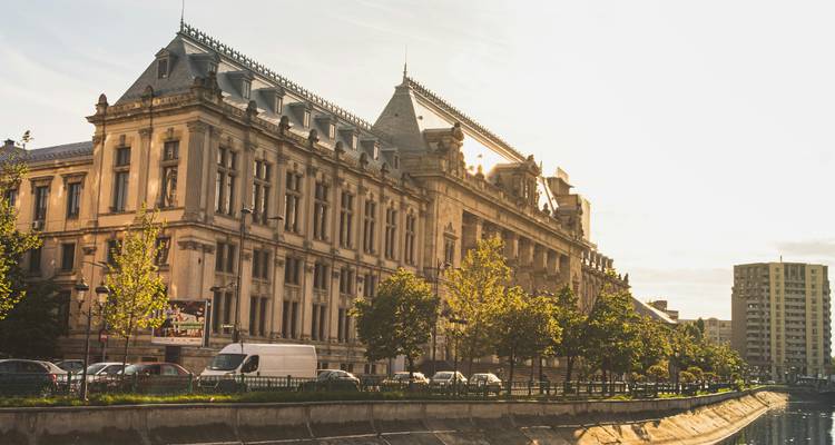 Elegant historic building along a canal in warm late afternoon light in Bucharest