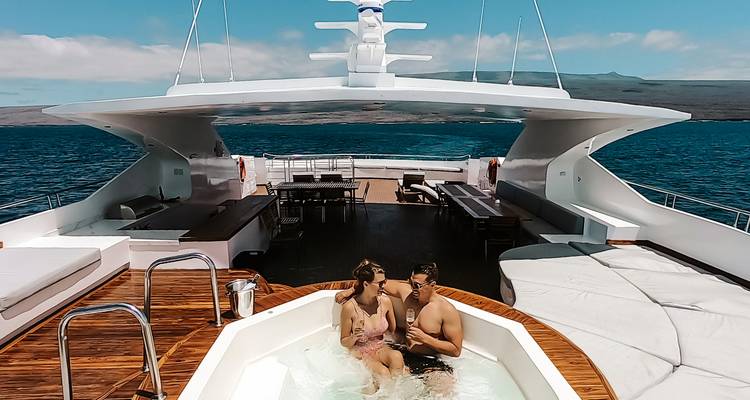 Couple relaxing in a jacuzzi on the deck of a luxury yacht in the Galapagos Islands