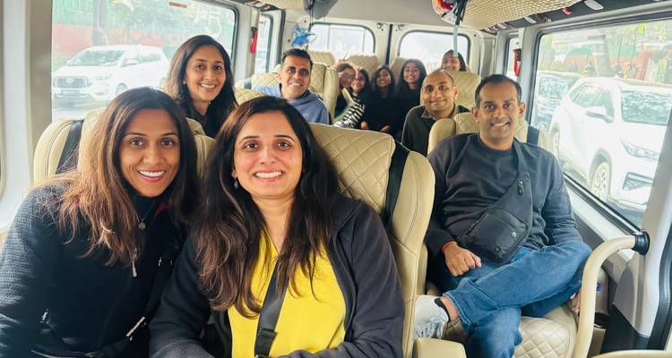 Large group of travellers seated inside a tour minibus ready for departure
