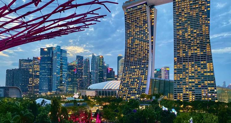 Evening skyline of Singapore with Marina Bay Sands and illuminated skyscrapers under twilight clouds