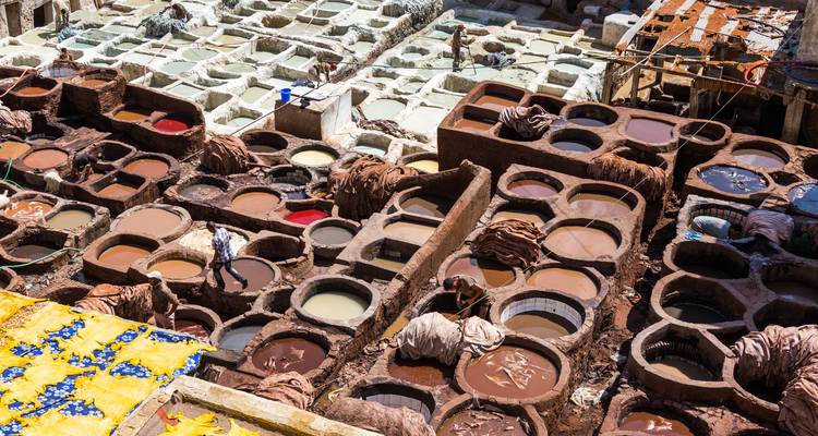 Bird’s-eye view of Fes tannery vats filled with colorful dyes and leather hides
