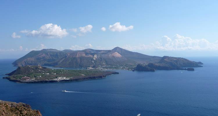 Panoramic aerial of the island of Vulcano with craters and blue sea all around