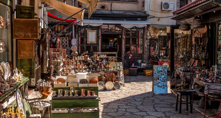 Enge BasarGasse voller Kupferwaren, Keramik und traditioneller Souvenirs unter warmem Sonnenlicht.