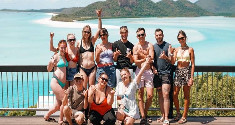 Large group posing on a viewing deck overlooking Whitehaven Beach’s brilliant turquoise waters