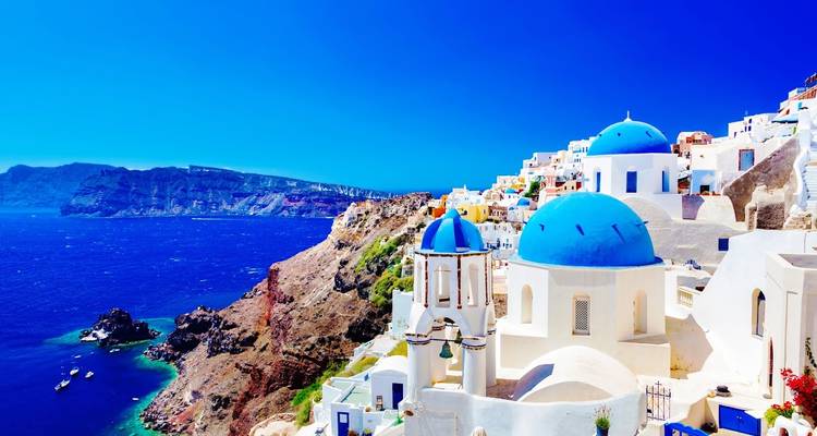 Brilliant azure sea and iconic blue-domed churches perched on Santorini’s volcanic caldera.