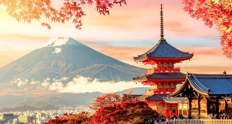 Chureito Pagoda and vivid autumn foliage with majestic snow-capped Mount Fuji towering behind.