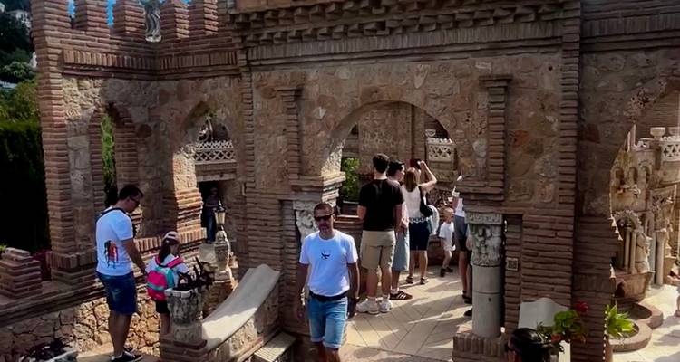 Visitors wander through ornate brick arches and miniature castles at Colomares Monument.