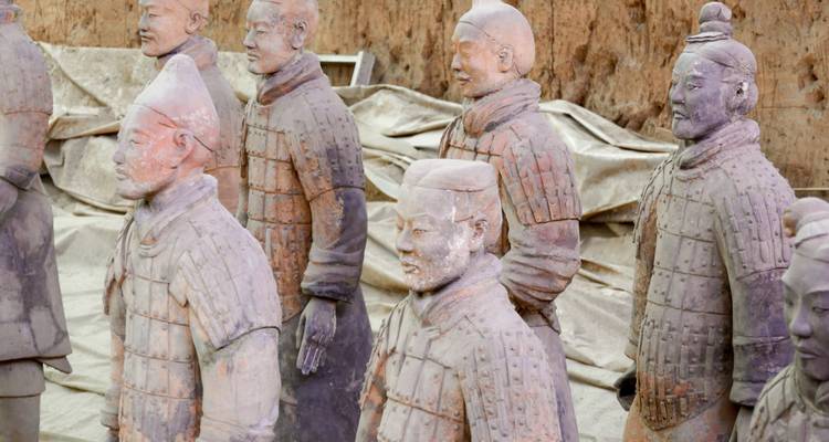 Row of life-size Terracotta Warrior statues inside the Xi’an excavation pit.