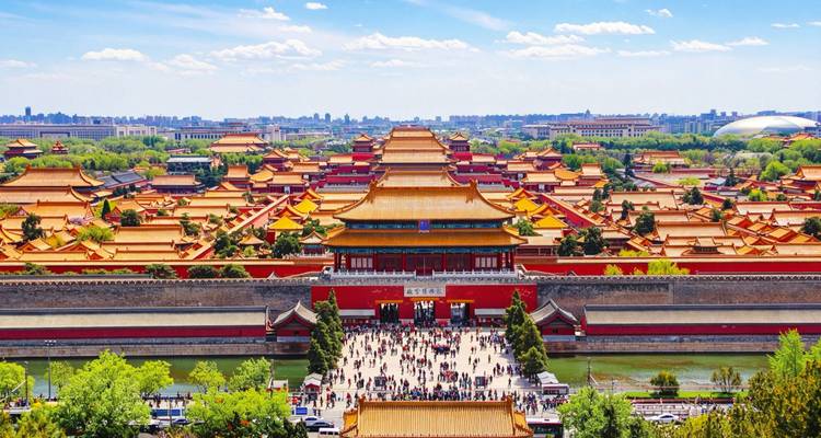 Aerial view of Beijing’s Forbidden City with crowds at the Meridian Gate surrounded by imperial yellow roofs.
