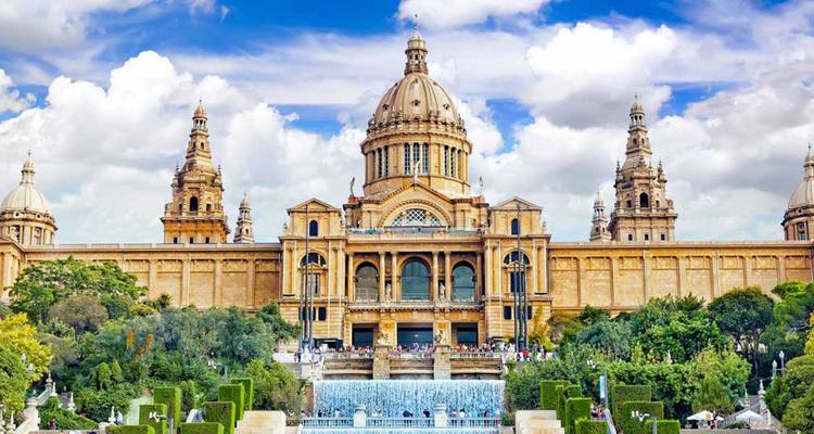 Palau Nacional in Barcelona framed by fountains and manicured gardens on a bright day.
