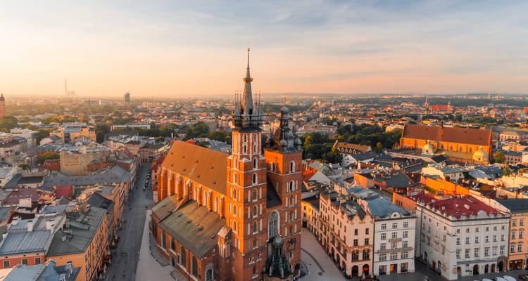 Soft sunrise light over Kraków’s St. Mary’s Basilica towering above the historic cityscape.