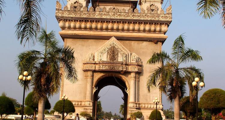 Patuxai-Siegesdenkmal, umrahmt von Palmen unter einem klaren blauen Himmel