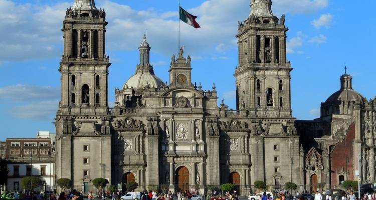 Front façade of Mexico City Metropolitan Cathedral dominating the Zócalo with crowds below