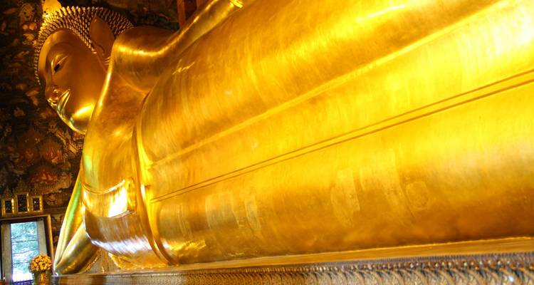 Close-up angle of the golden Reclining Buddha at Wat Pho capturing its serene face and body.