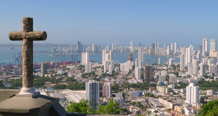 Panoramic cityscape of Cartagena with modern skyscrapers and harbour viewed from a hilltop cross.