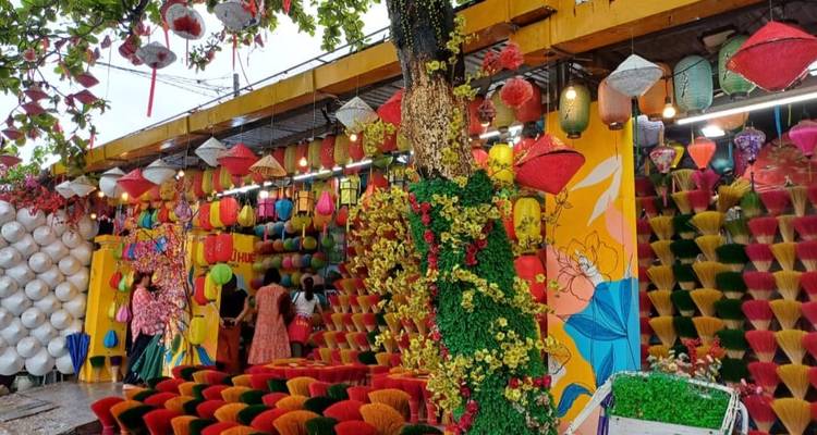 Colorful incense sticks and lanterns displayed at a bustling craft stall in Hue.