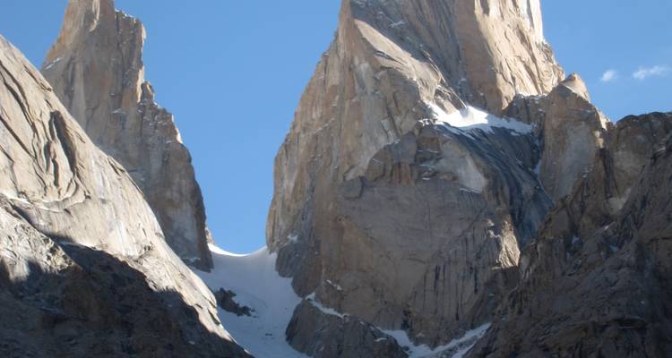 Close-up of towering granite buttresses with a steep snow chute between sheer walls.