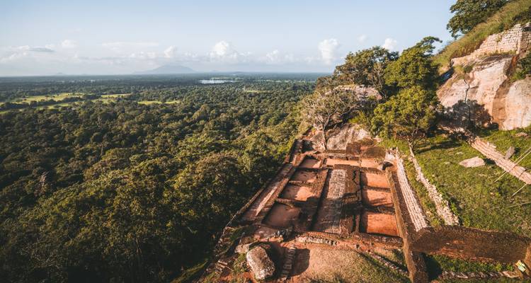 Panoramic aerial view from Sigiriya rock fortress overlooking ancient ruins and vast jungle plains