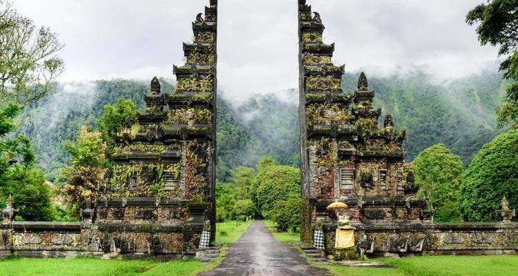 Iconic split gate temple surrounded by misty jungled mountains on Bali