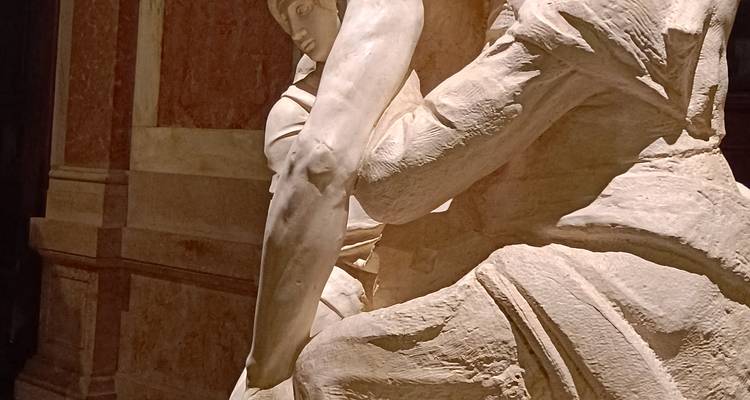 Detail of a Renaissance marble sculpture inside a dimly lit hall
