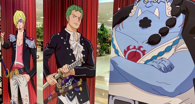 Indoor display of large vertical banners featuring popular One Piece anime characters.