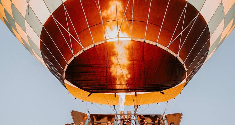 Close-up view underneath a hot-air balloon as the burner flame shoots upward