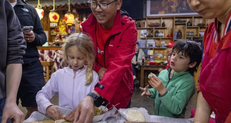 A group of people participating in a dumpling-making class.