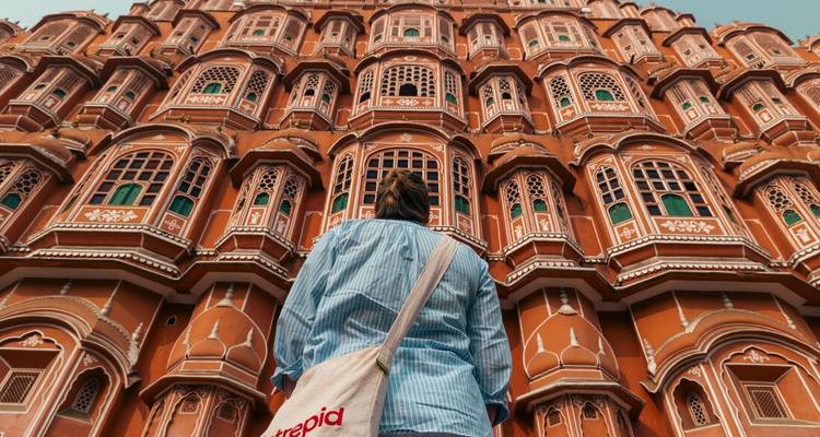 Person looking up at the Hawa Mahal's intricate facade.