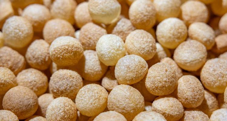 Close-up van goudgele knapperige ronde Indiase zoetigheden op een stapel
