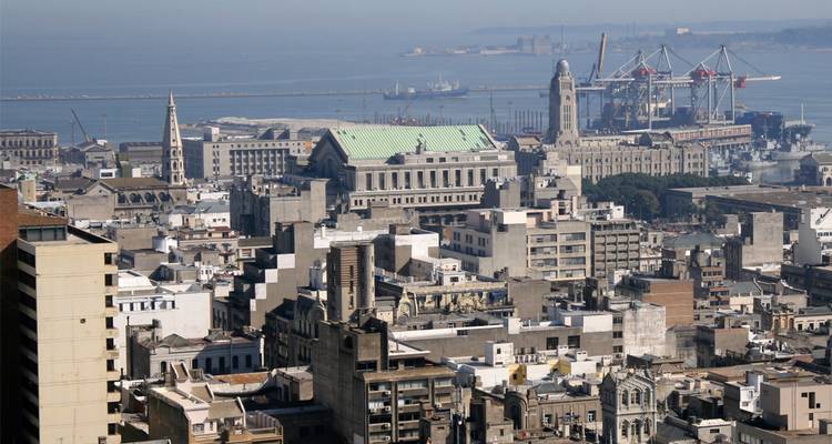 Skyline urbain de Montevideo avec des bâtiments historiques et des grues portuaires le long du front de mer