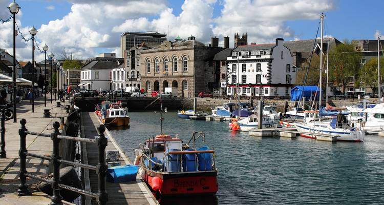 Harbor scene with boats and historic buildings.
