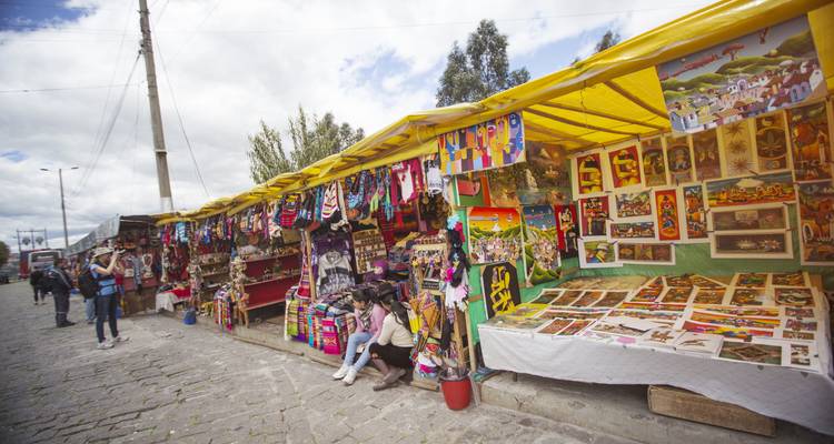 Outdoor market scene with colorful crafts and tourists.