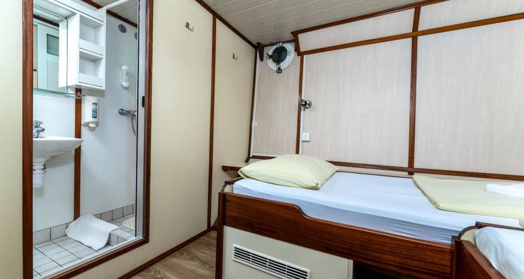 Small cabin with a sink and bathroom view.