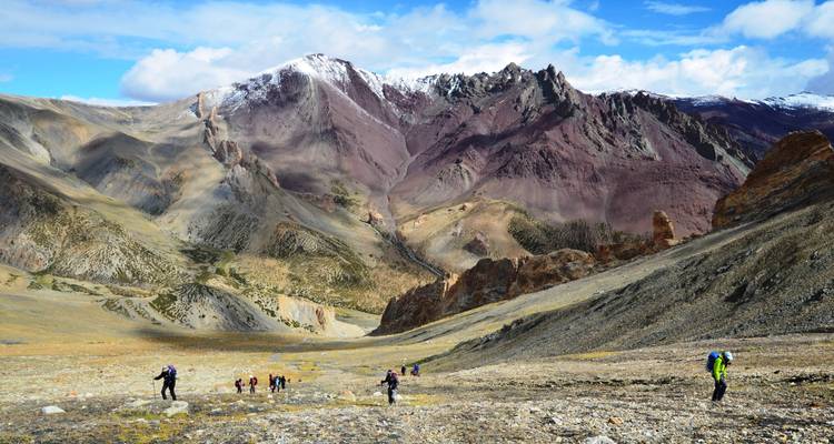 Randonneurs sur un sentier dans un paysage de montagne.