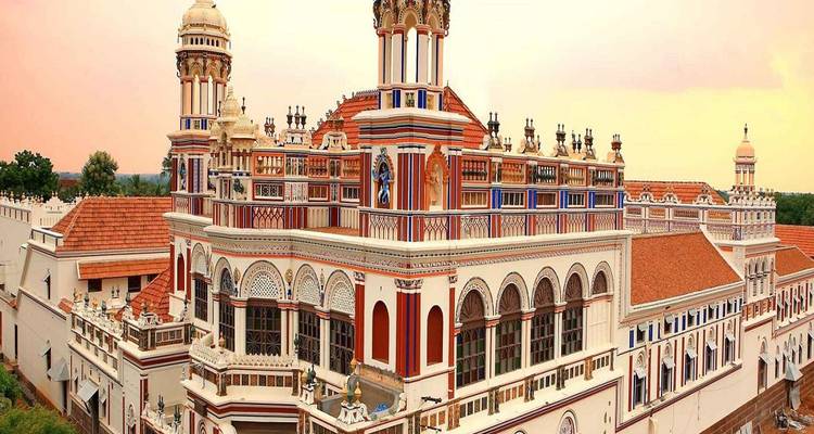 Un palais orné avec une architecture colorée et un ciel chaleureux.