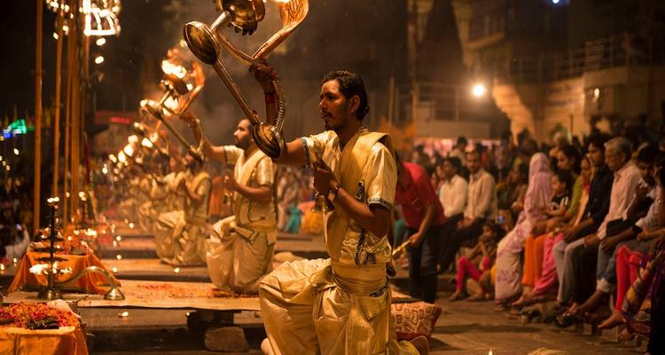 Cérémonie du soir au bord de la rivière avec des personnes en tenue traditionnelle.