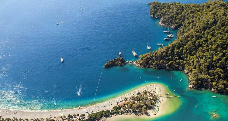 Aerial view of Oludeniz’s curved sand spit and turquoise lagoon framed by lush green hills
