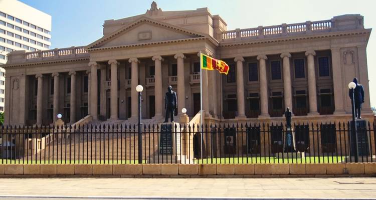 Majestic administrative building with national flags.