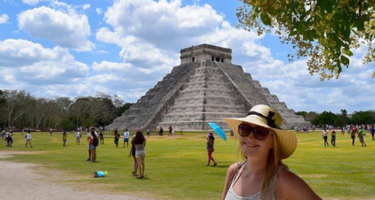 Chichen Itza pyramid with a woman posing.