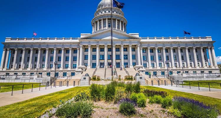 Front view of the neoclassical Utah State Capitol building under a vivid blue sky.