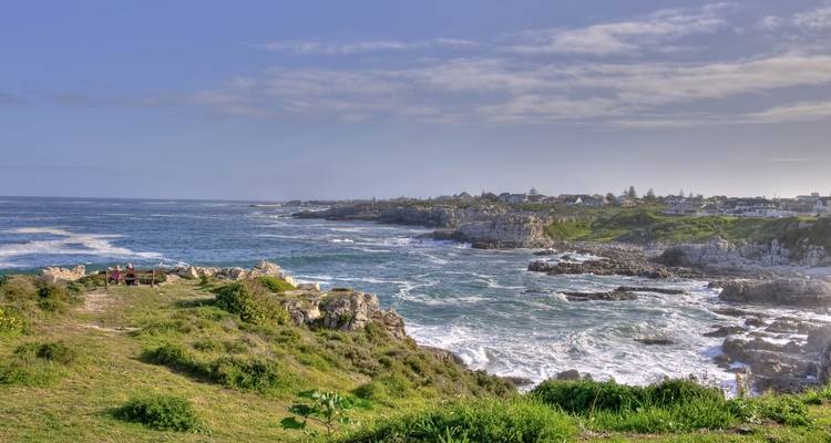 Coastal landscape with rocky shores and distant villages.