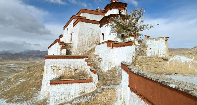 A large temple on a rocky hill with a clear sky.