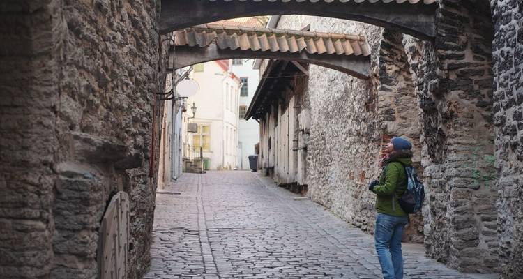 A person walking through a charming historic street.