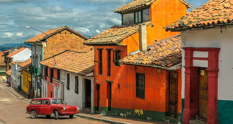 Colorful colonial buildings in a street in Bogota with a vintage car.