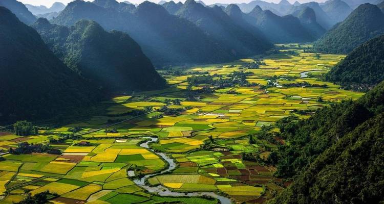 Scenic view of a colorful agricultural valley surrounded by mountains.