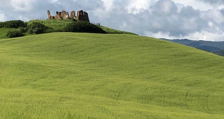 Rolling hills with ruins of an ancient structure.