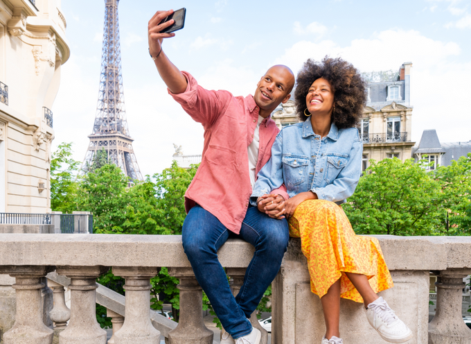 Group of people sitting in a Jeep looking at elephants whilst on safari in Africa