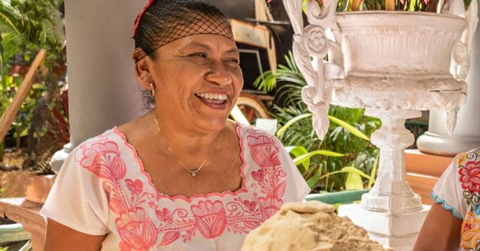 A woman in Mexico creating taco wraps by hand over