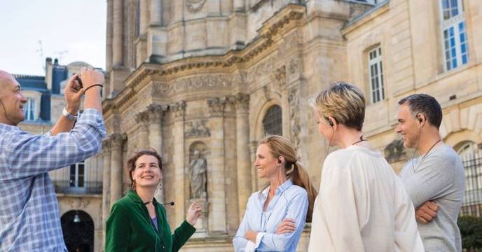 A cruise director and her group on a  walking tour shore excursion through a historic European city